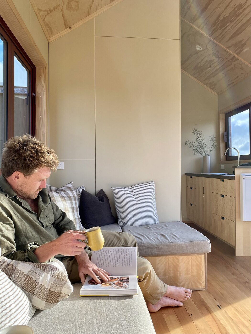 Morning coffee on the window seat of a Raglan Tiny Home